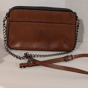 Patricia Nash brown leather crossbody bag with a chain strap. 